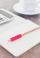 Notebook with a pencil and calculator photo