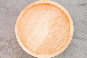 Wooden plate on a grey background photo