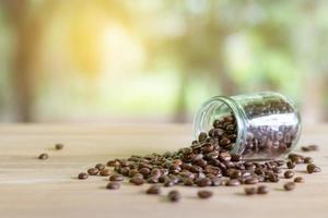 Roasted coffee beans in glass bottles photo