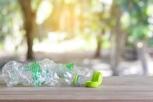 Clear empty plastic bottle on wooden table photo