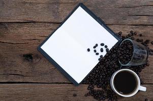 Wooden desk with coffee and notebook photo