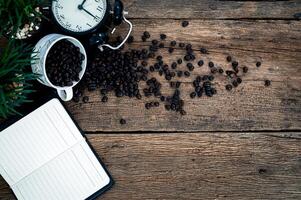 Notebook and coffee on wooden table, top view photo