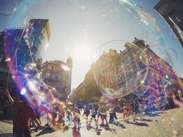 Prague, Czech Republic, 2020 - Group of people blowing bubbles in a city photo