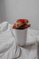 Pieces of toast on a cup photo