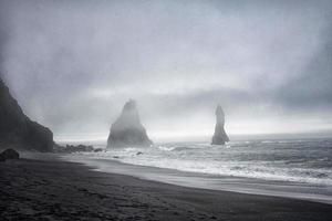 Grainy photo of two rocks in the sea