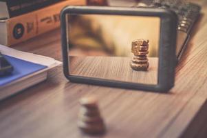 Black framed mirror on the brown wooden table photo