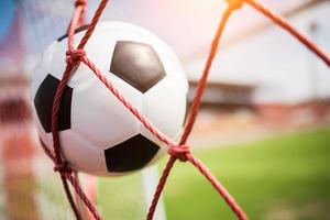 Soccer ball soars into goal net photo