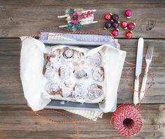 Cinnamon buns with cream-cheese icing in a baking dish with photo