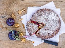 Plum cake with walnuts and fresh ripe plums photo