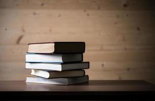 Stack of books on wooden table photo