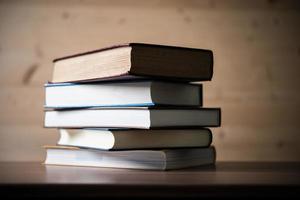 Stack of books on wooden table photo