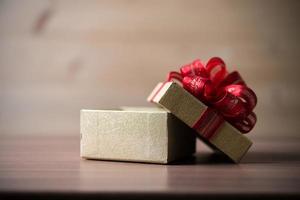 Small gift box on wooden background photo