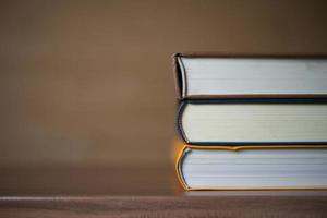 Stack of books on wooden table photo