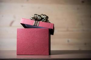 Gift box on wooden background photo