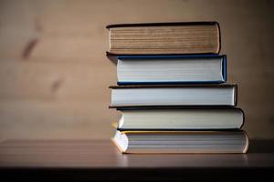 Stack of books on wooden table photo