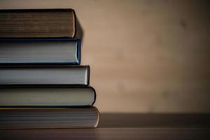 Stack of books on wooden table. photo