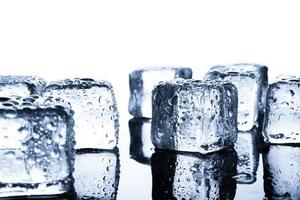 Close-up of wet ice cubes on minimal background photo