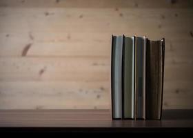 Stack of books on wooden table. photo