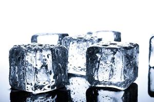 Close-up of wet ice cubes on minimal background photo