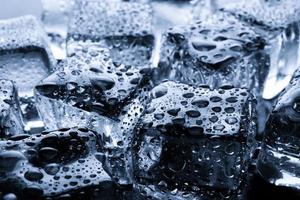 Close-up of wet ice cubes on minimal background photo
