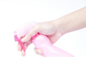 Close-up of a hand holding the trigger of a spray bottle photo