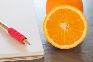 Oranges next to a notebook photo