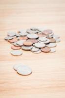 Coins on a wooden table photo