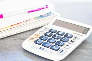 Calculator on a table with a notebook photo