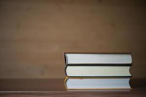 Stack of books on wooden table photo