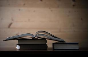 Close-up of opened book on wooden table photo