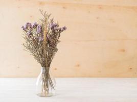 Statice and caspia flowers on wooden background photo