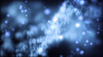 Light blue bokeh lights of different sizes floating on dark background video