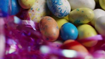 Rotating shot of colorful Easter candies on a bed of easter grass - EASTER 138 video