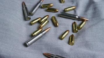 Cinematic rotating shot of bullets on a fabric surface - BULLETS 088 video