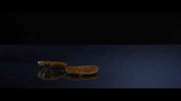 Falling cookies from above onto a reflective surface - COOKIES 190 video