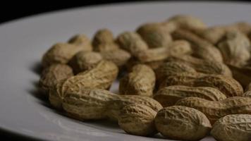 Cinematic, rotating shot of peanuts on a white surface - PEANUTS 014 video