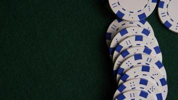 Rotating shot of poker cards and poker chips on a green felt surface - POKER 057 video