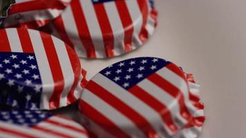 Rotating shot of bottle caps with the American flag printed on them - BOTTLE CAPS 035 video