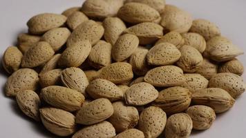 Cinematic, rotating shot of almonds on a white surface - ALMONDS 138 video