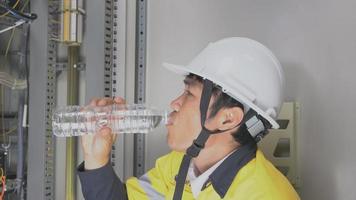 A maintenance technician drinking water video