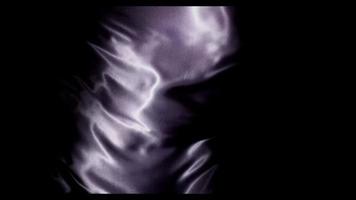 Dark purple fabric moved by the wind with big diagonal waves from upper left and right corner in 4K video