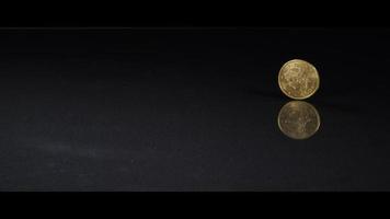 Spinning coin on a reflective surface - MONEY 0047 video