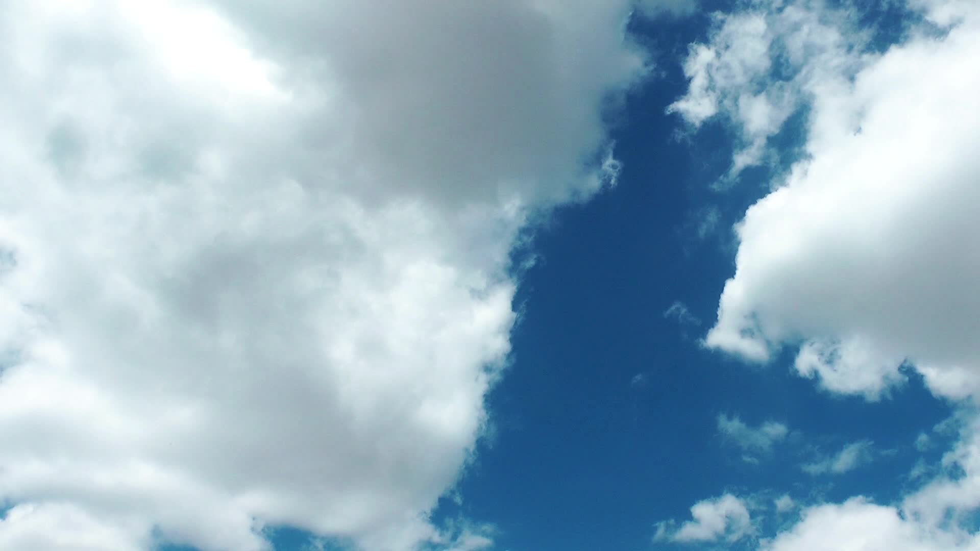 White Cumulus Rain Clouds Spreading Slowly Below The Blue Sky 1786636 Stock Video at Vecteezy