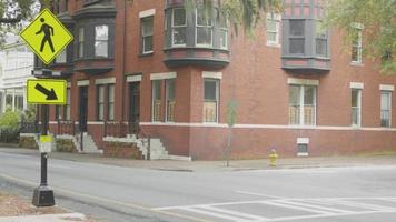 Handheld Clip Of Brick Building With People Walking In Foreground video