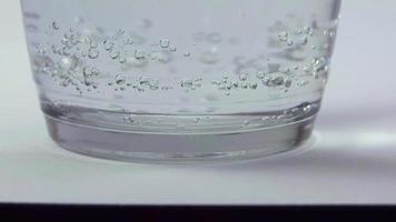 Extreme Close Up To Glass Bottom With Carbonated Liquid video