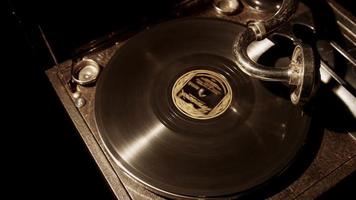 Medium panning shot top view from left to right of classic record player with vinyl disc spinning on turntable in 4K video