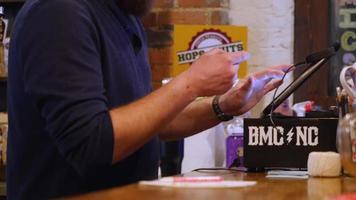 Bartender using iPad to type in credit card | Free Stock Footage video