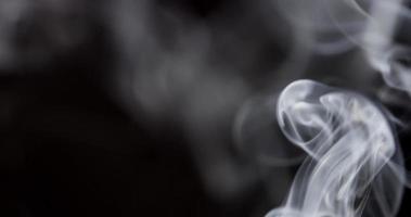 White smoke column floating from lower right corner, then from lower left corner in 4K video