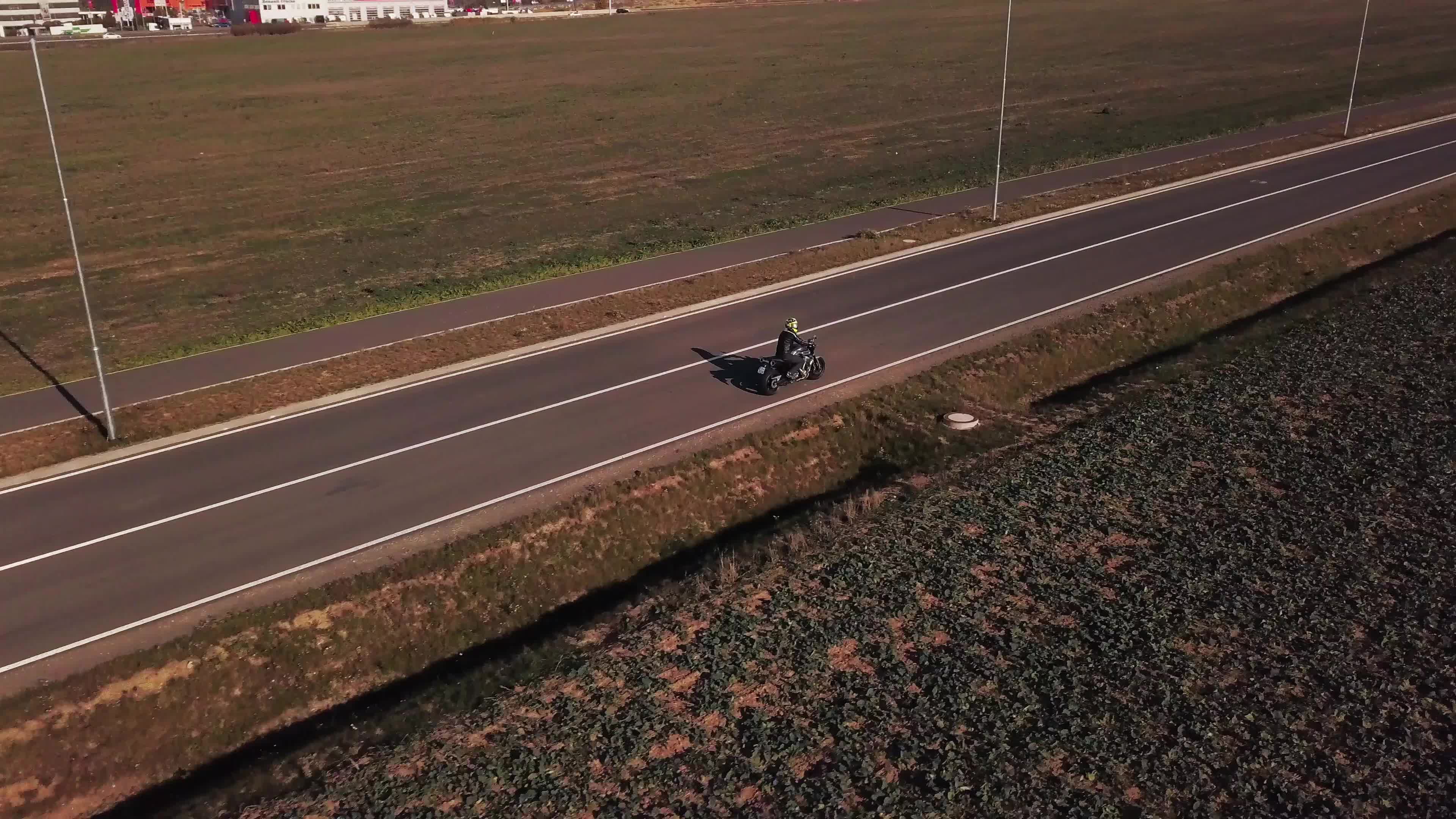 Drone follows a motorbike from right back profile in 4K 1787654 Stock