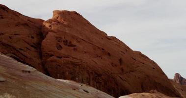 Tiro de viaje diagonal subiendo de la colina roja en paisaje desértico en 4k video